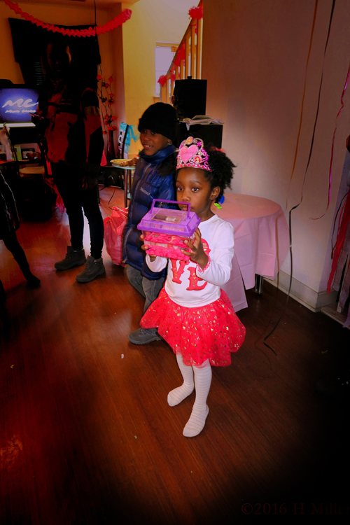 The Birthday Girl Holding Her Gift She Just Received. The Birthday Girl Holding Her Gift She Just Received.