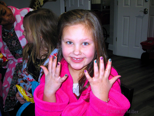 Kids Party Guest Posing With Her Multicolored Sparkle Girls Manicure
