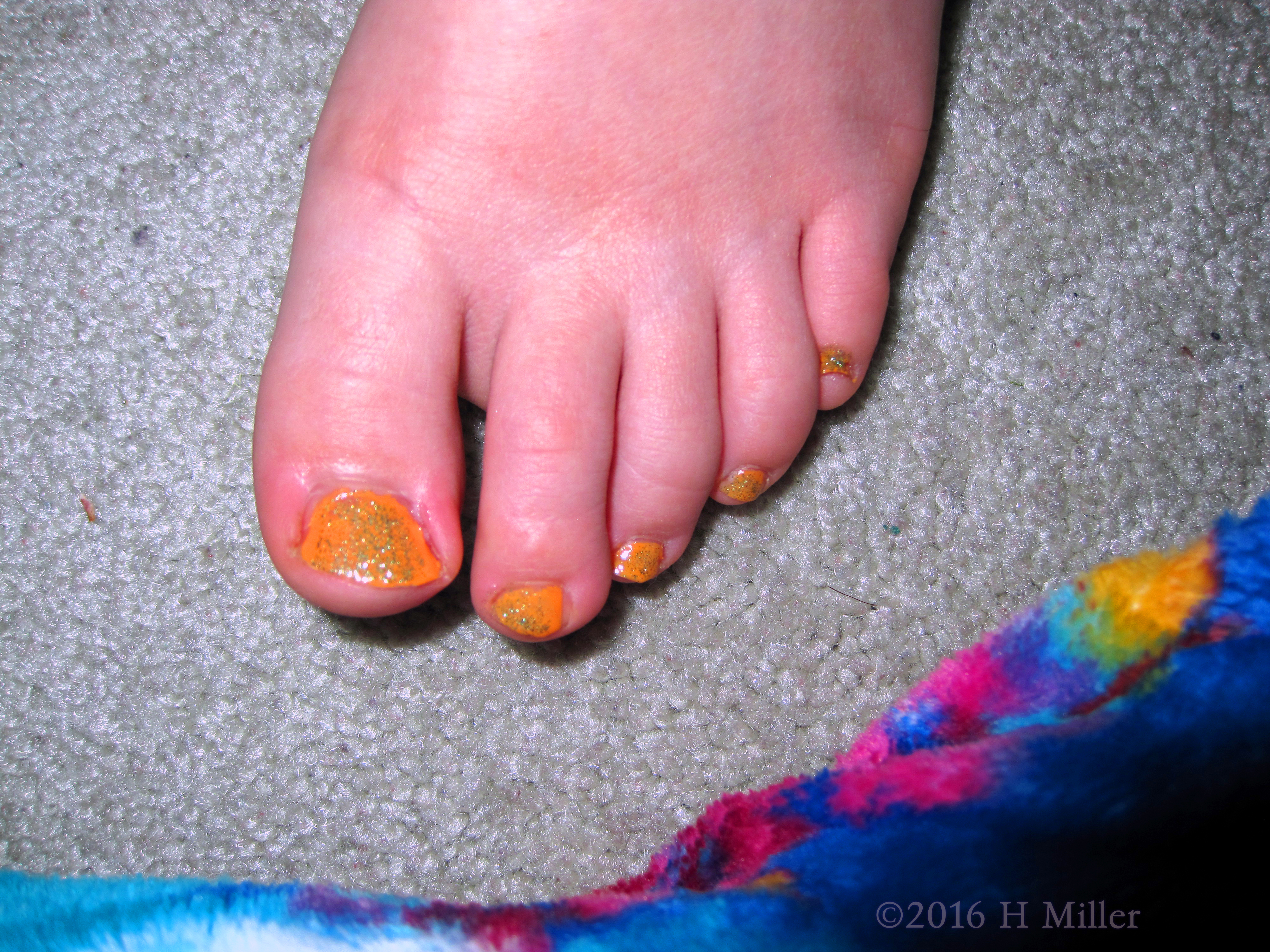 A Pretty Glittery Orange For This Girls Pedicure. A Pretty Glittery Orange For This Girls Pedicure.
