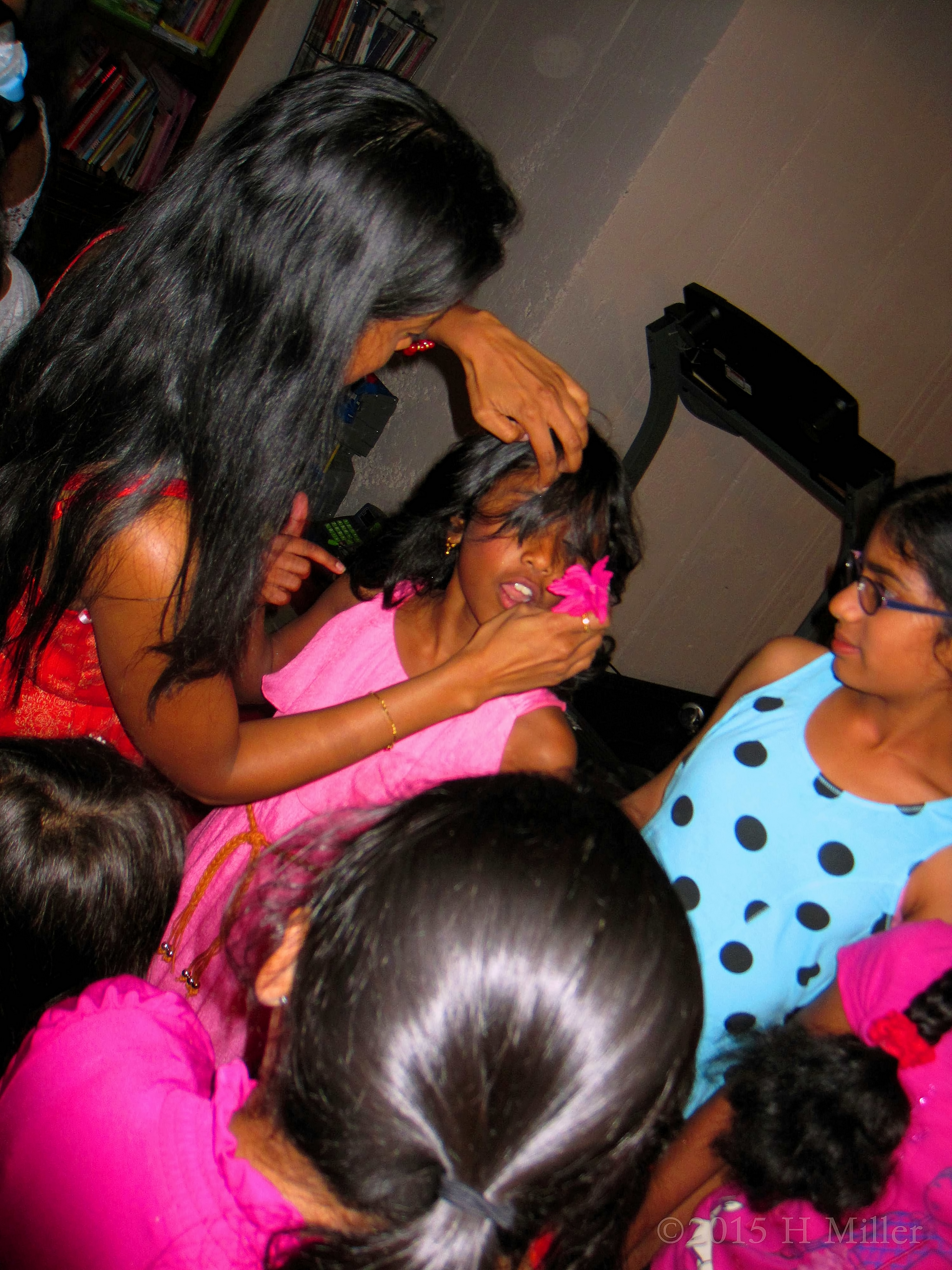 Adjusting The Birthday Girl's Flower In Her Hair. Adjusting The Birthday Girl's Flower In Her Hair.