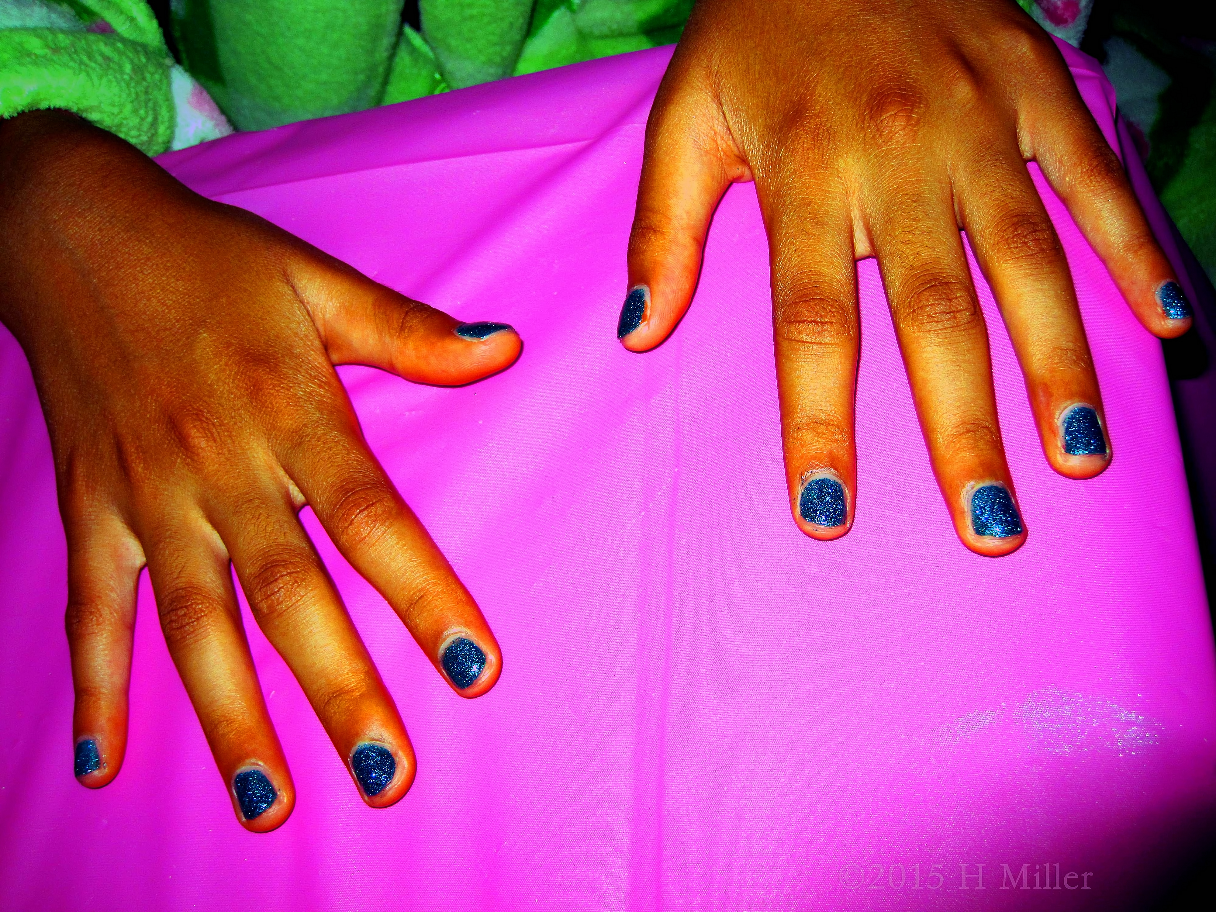 Kids Manicure With Midnight Blue Metallic Nail Polish. Kids Manicure With Midnight Blue Metallic Nail Polish.