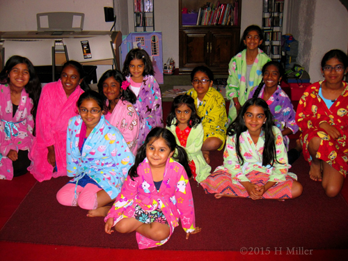Group Picture Of Harini And Her Spa Birthday Party Guests Wearing Colorful Robes.