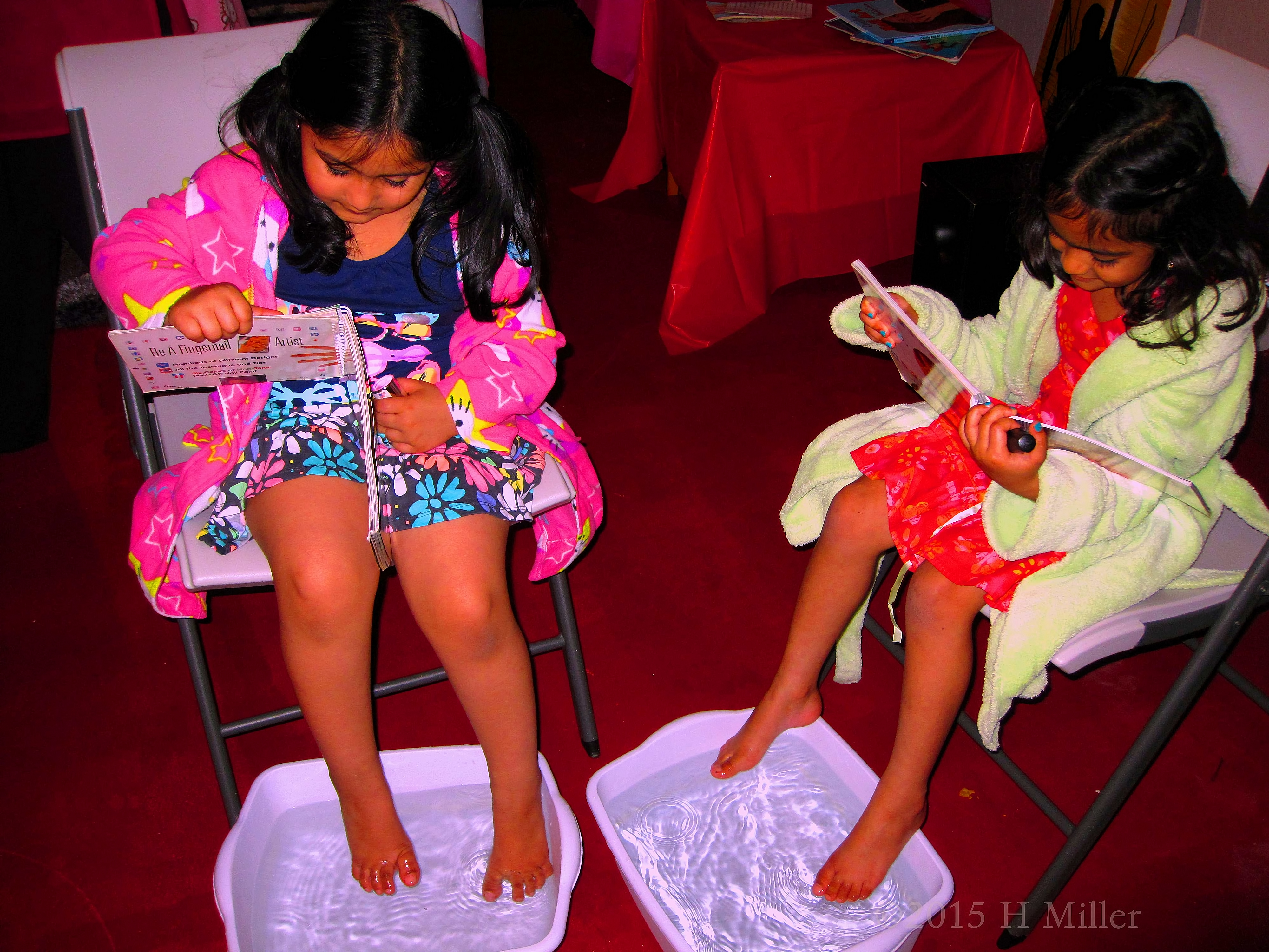 Looking Through Books During Their Pedi Footbath Looking Through Books During Their Pedi Footbath