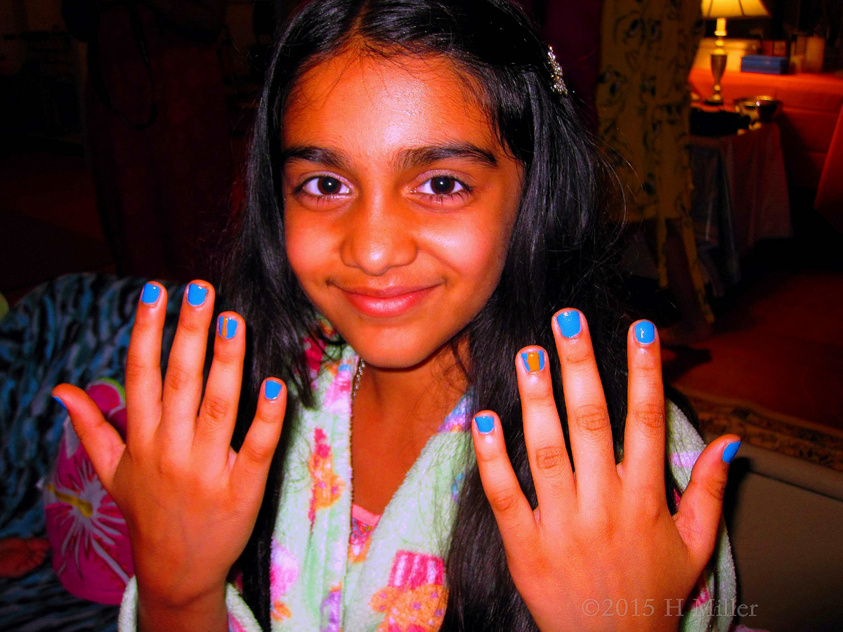 Her Kids Manicure Has An Orange Line On Blue Polish 