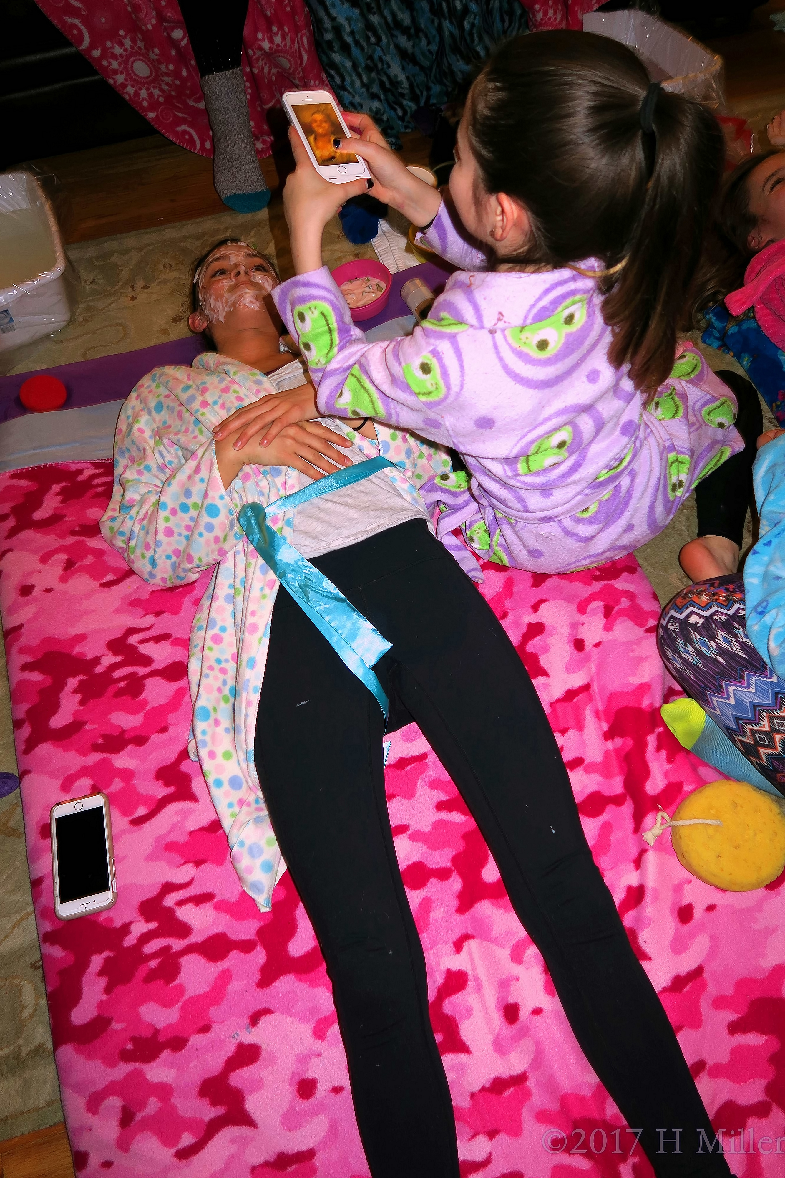 Girl Is Taking A Photo Of Her Friend During Girls Facials Girl Is Taking A Photo Of Her Friend During Girls Facials