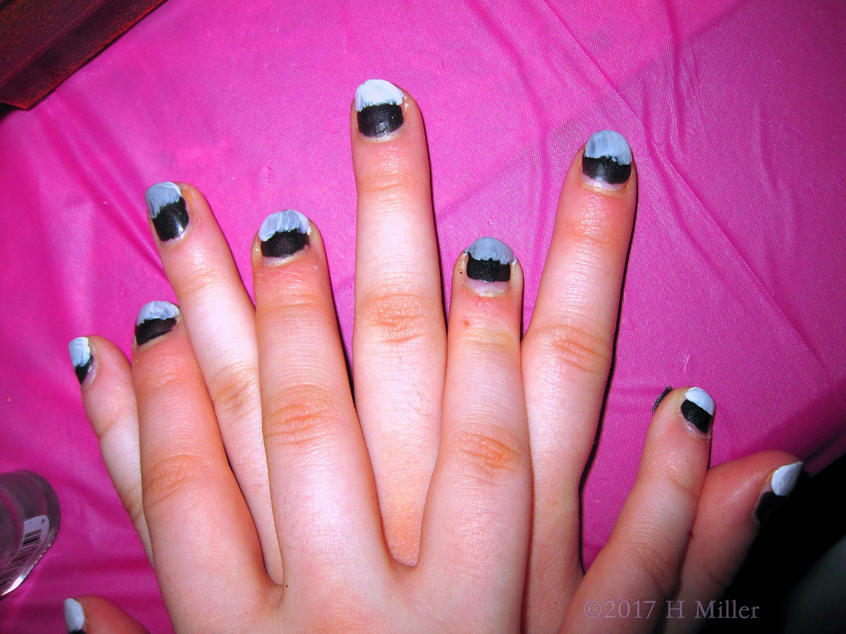 A Very Lovely Girls Manicure With Blue And Black 