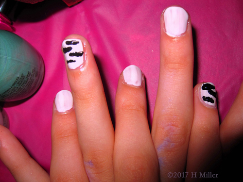 A Closeup Of The Black And White Girls Manicure