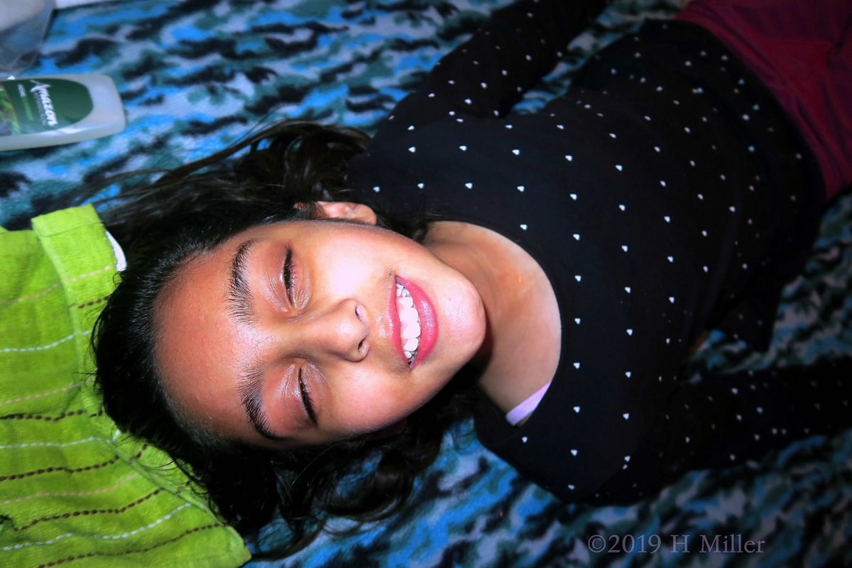 Smiling Guest Getting A Facial For Girls At The Teens Birthday Party 