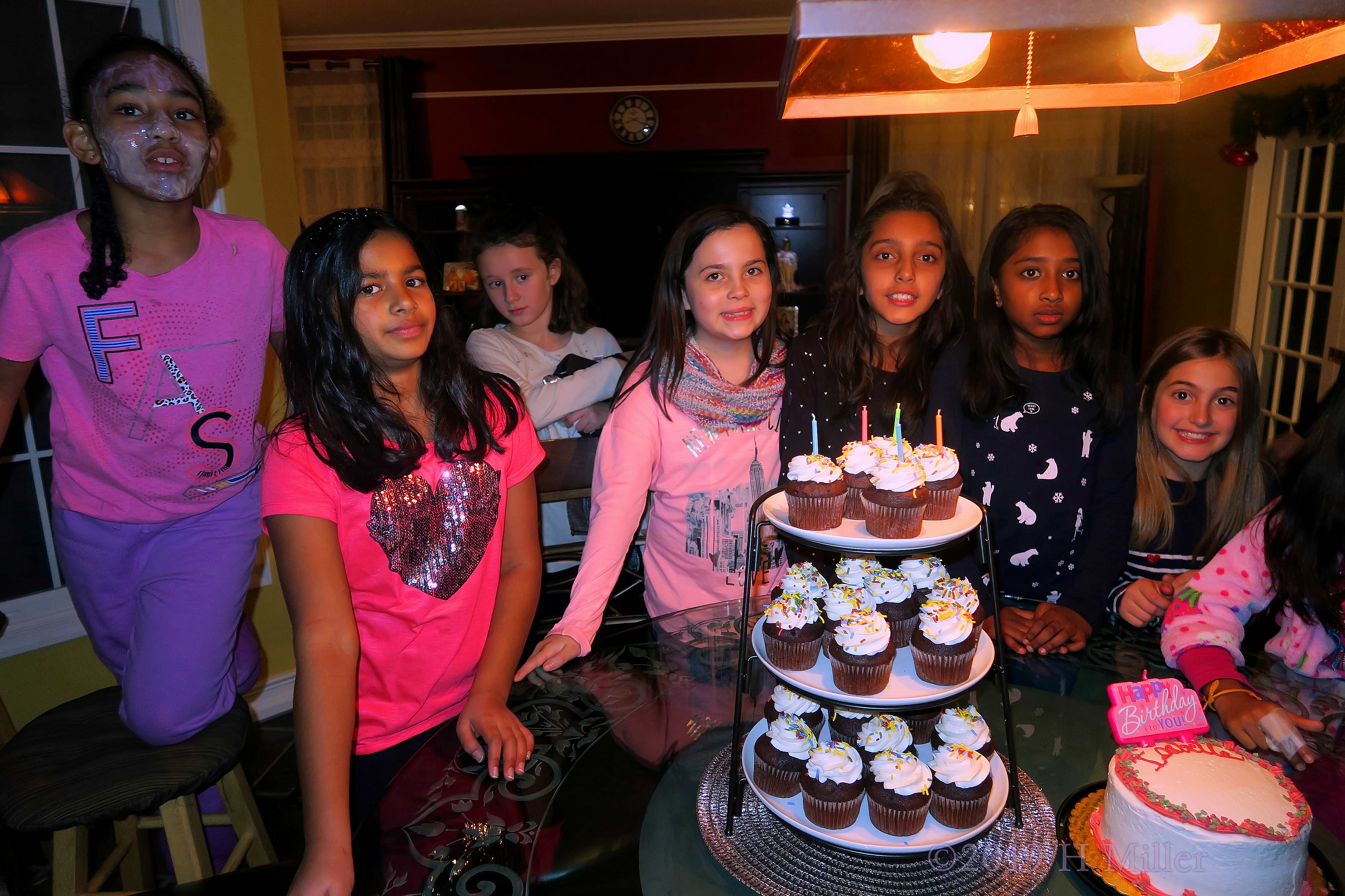 Girls Are Posing With The Cupcakes And Birthday Cake With Big Smiles At The Spa Birthday Party 