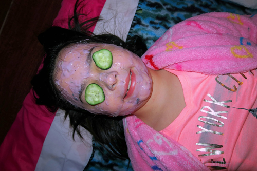 A Close Up On This Guest;s Kids Facial With Cukes