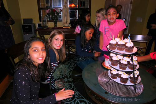 Smiling Girls At The Dining Table WIth Cupcakes Smiling Girls At The Dining Table WIth Cupcakes