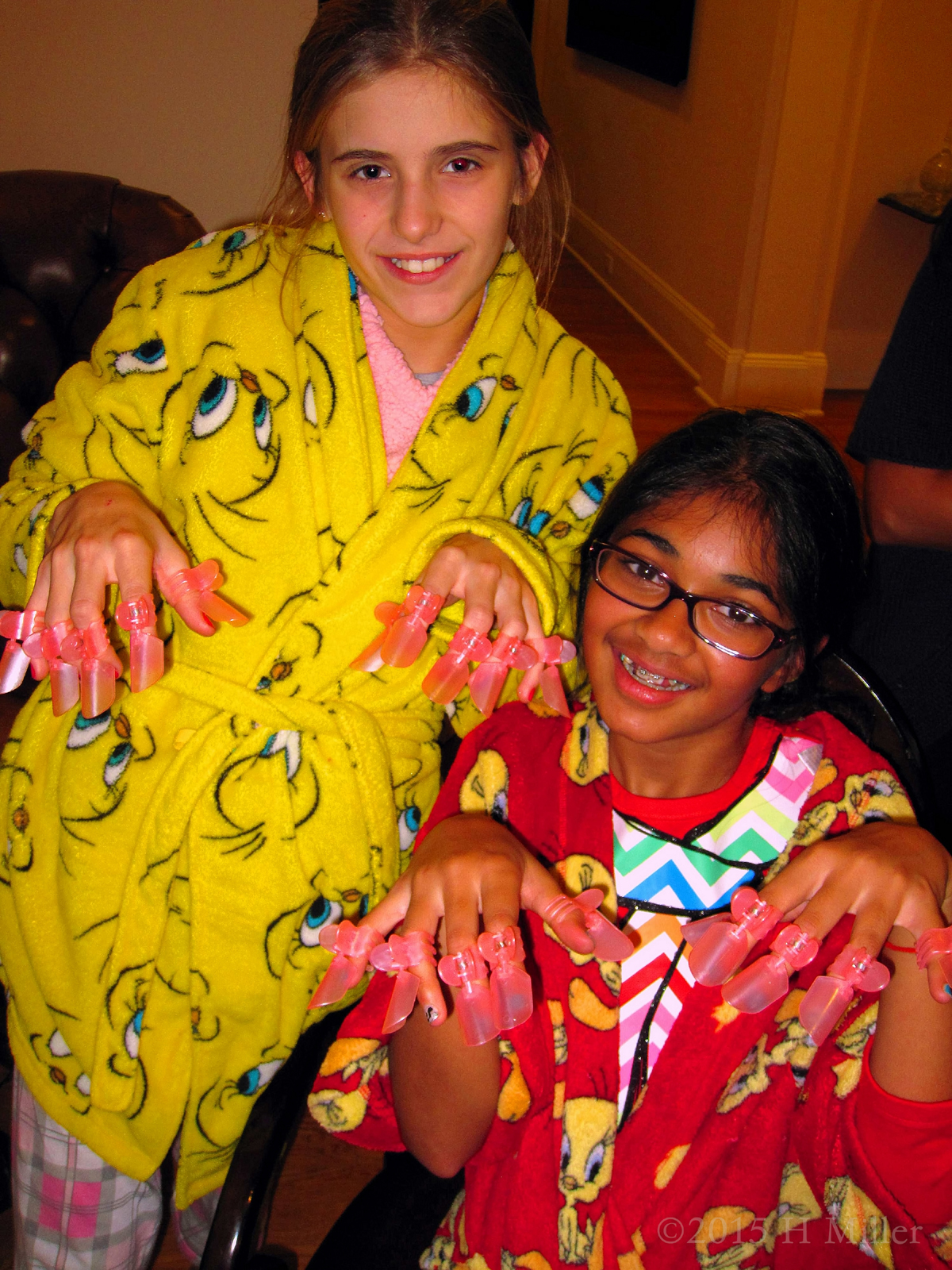 The Birthday Girl And Her Friend With Her Manicure And Nail Protectors At The Kids Home Spa 