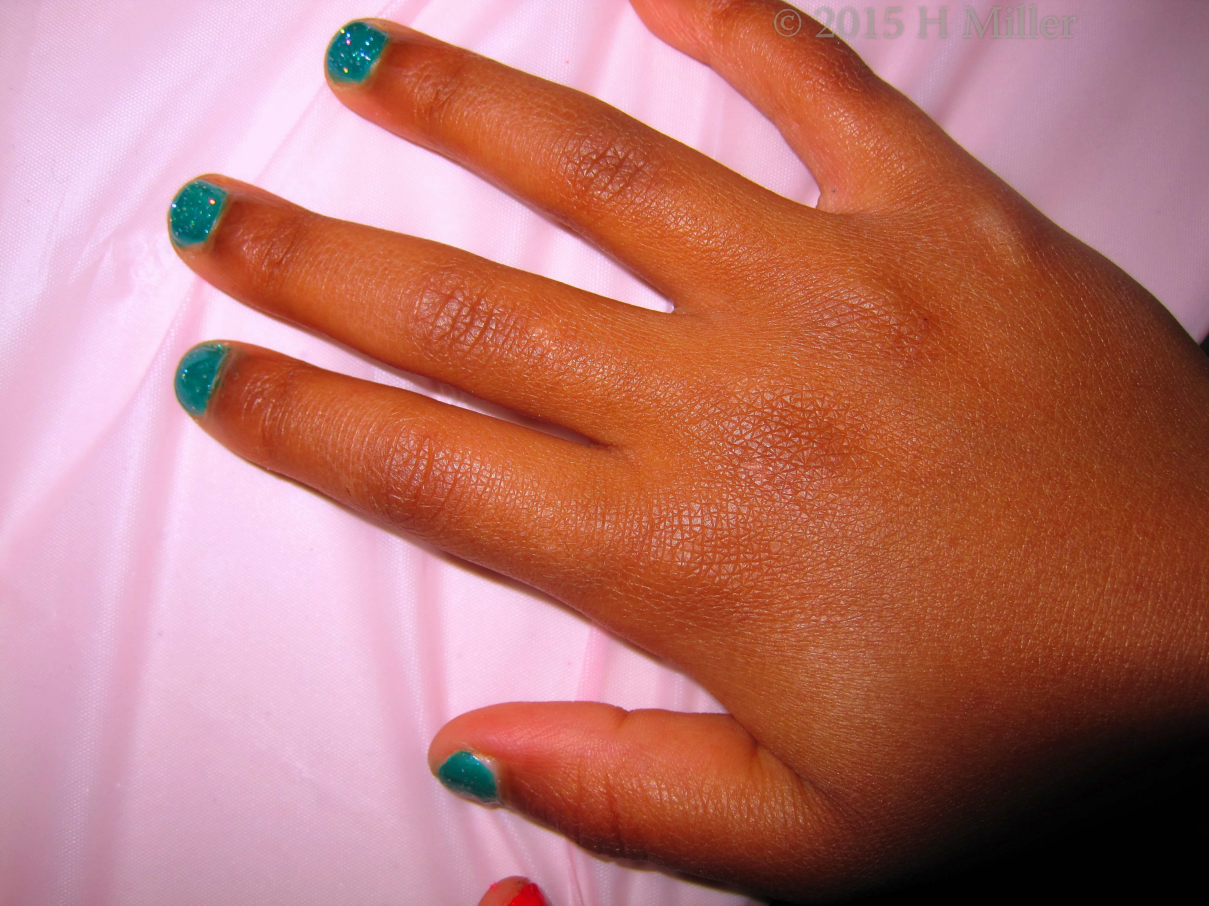 Green Polish With Silver Glitter Close Up. Green Polish With Silver Glitter Close Up.