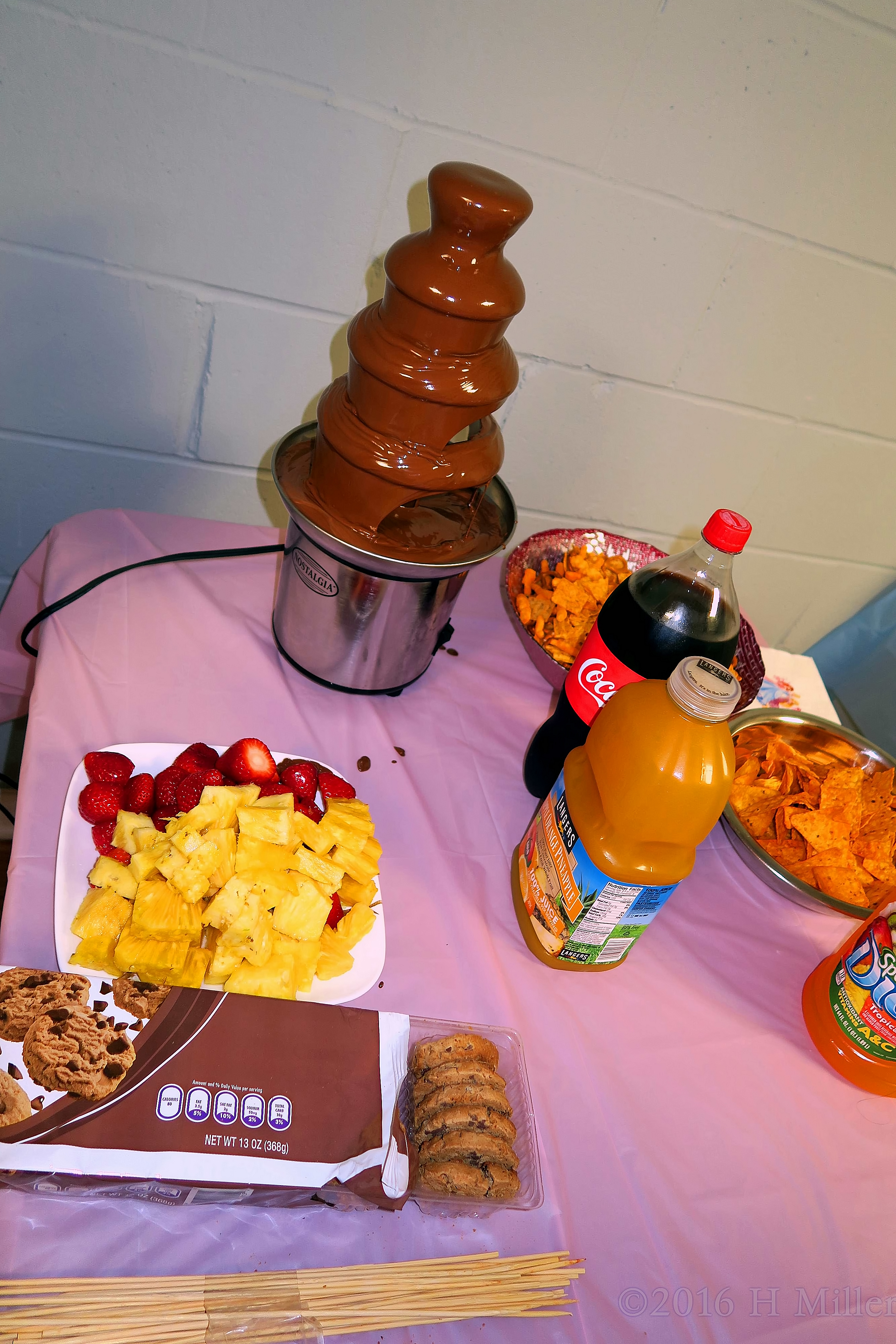 Yummy Snacks Including Chocolate Fondue In A Fountain, Strawberries, Pineapples, And Cookies! 