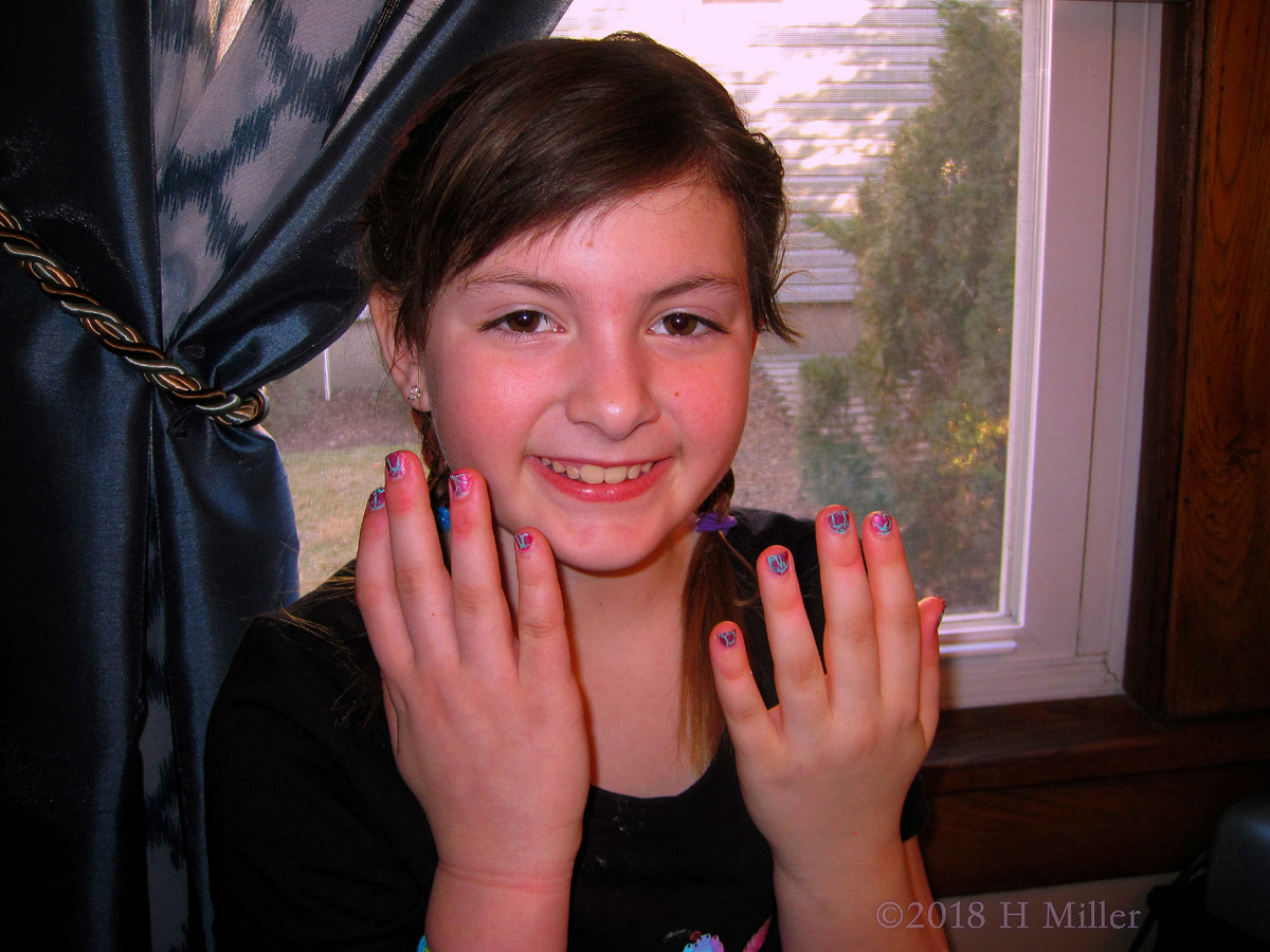 Party Guest Posing With Her Multicolored Kids Manicure