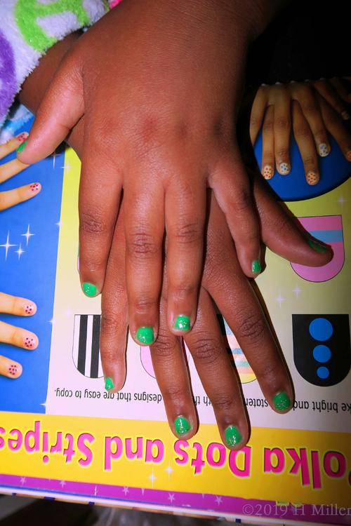 Beautiful Vibrant Green Girls Manicure With Glittery Silver Top Coat. 