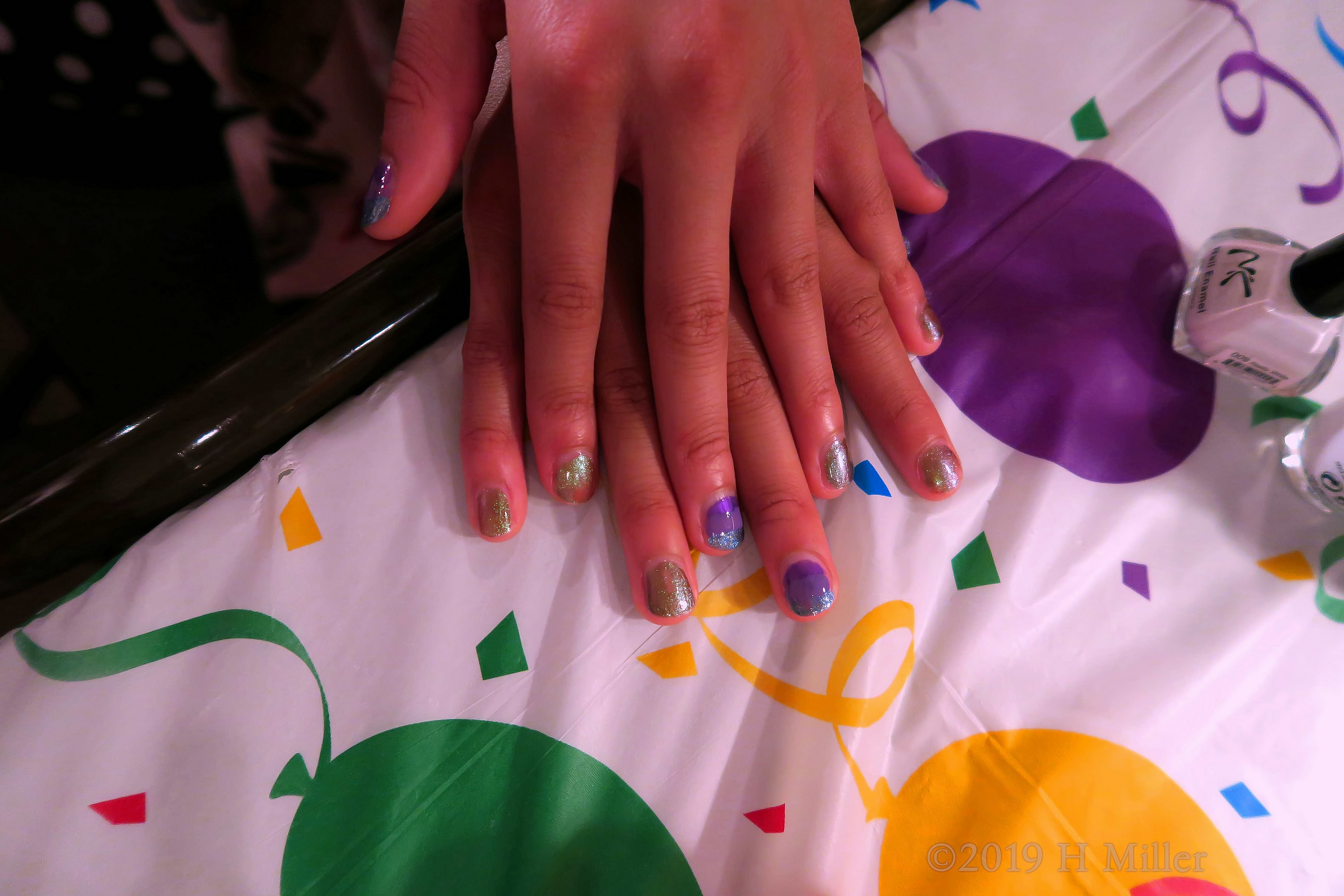 Glitter Glossiness........... Glitter Purple And Gold Nail Art With Accents Of Blue On This Kids Manicure. Glitter Glossiness........... Glitter Purple And Gold Nail Art With Accents Of Blue On This Kids Manicure.