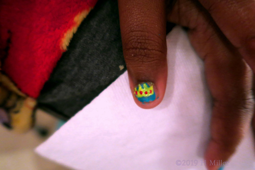 Blue Girls Manicure With Yellow And Red Crown Nail Design