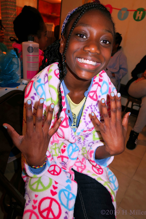 Party Guest Showing Off Her Sky Blue Kids Mini Manicure