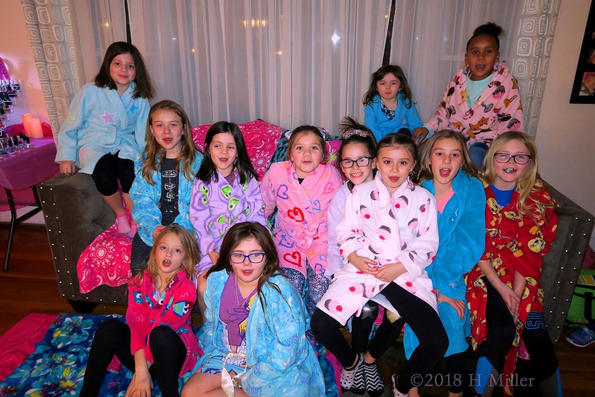 Party Guests Posing In Kids Spa Robes For Group Photo! 