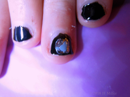 Kids Mani Black Polish With Heart Shaped Glitter On Accent Nails