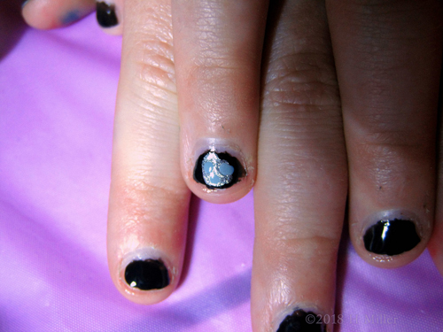 Zoom Up Of Heart Shaped Glitter On Black Shiny Polish For Kids Mani Zoom Up Of Heart Shaped Glitter On Black Shiny Polish For Kids Mani