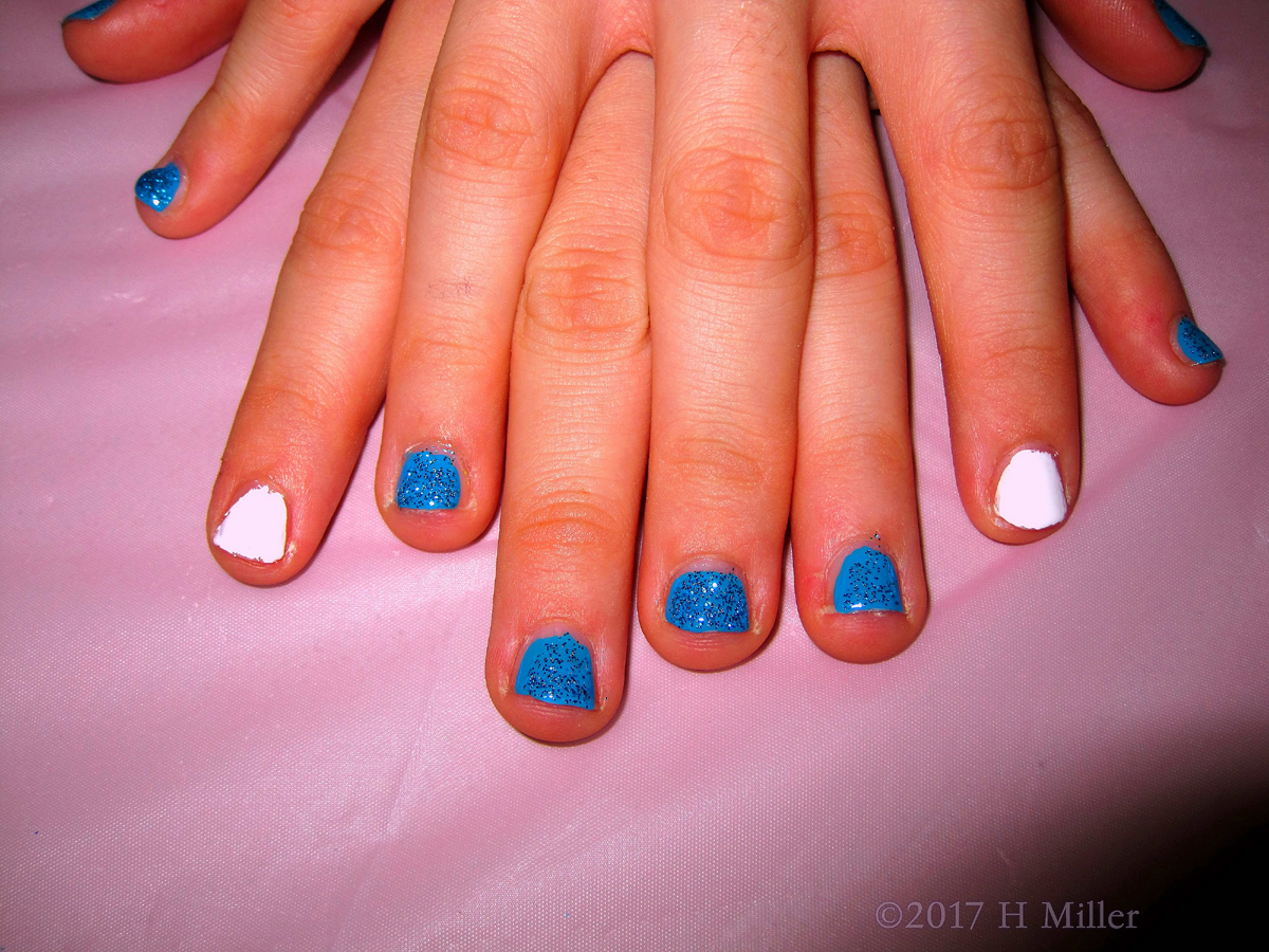A Perfect Combination Of White Accent Nail And Sparkly Blue Glitter For This Kids Manicure! 