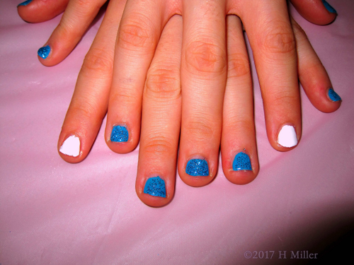 A Perfect Combination Of White Accent Nail And Sparkly Blue Glitter For This Kids Manicure!