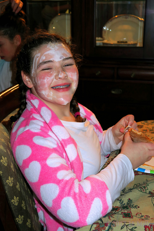 Happy Party Guest Is Smiling With Her Face Masque On Having Pizza At The Spa Birthday Party!