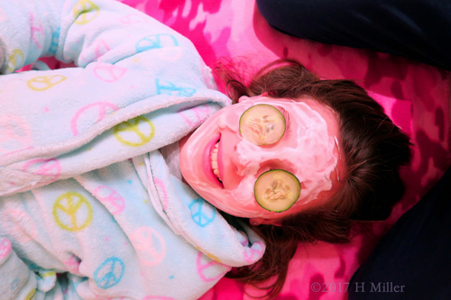 Healthy Mini Facial For Kids With Strawberry Face Masque And Cucumber On The Eyes At The Spa Birthday Party