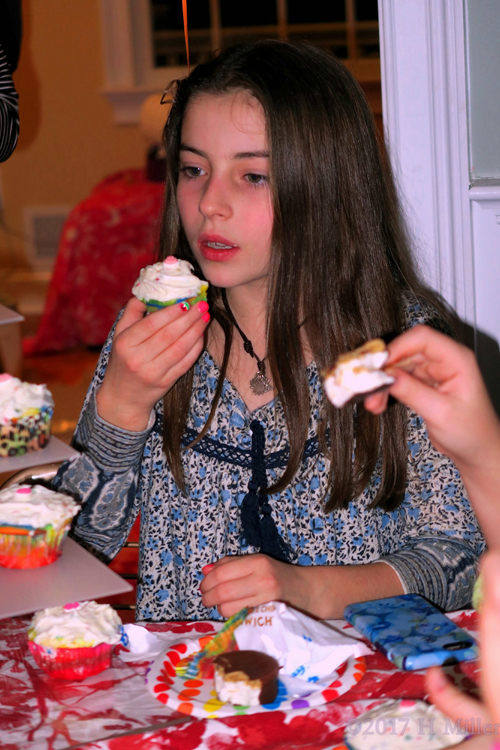 The Birthday Girl Is Eating A Cupcake