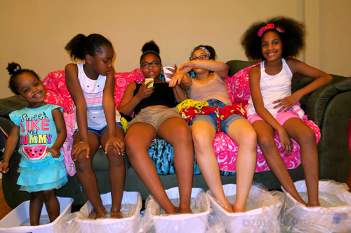 Everybody Is Hanging Out Together During Their Kids Pedicures At The Girls Spa Birthday.