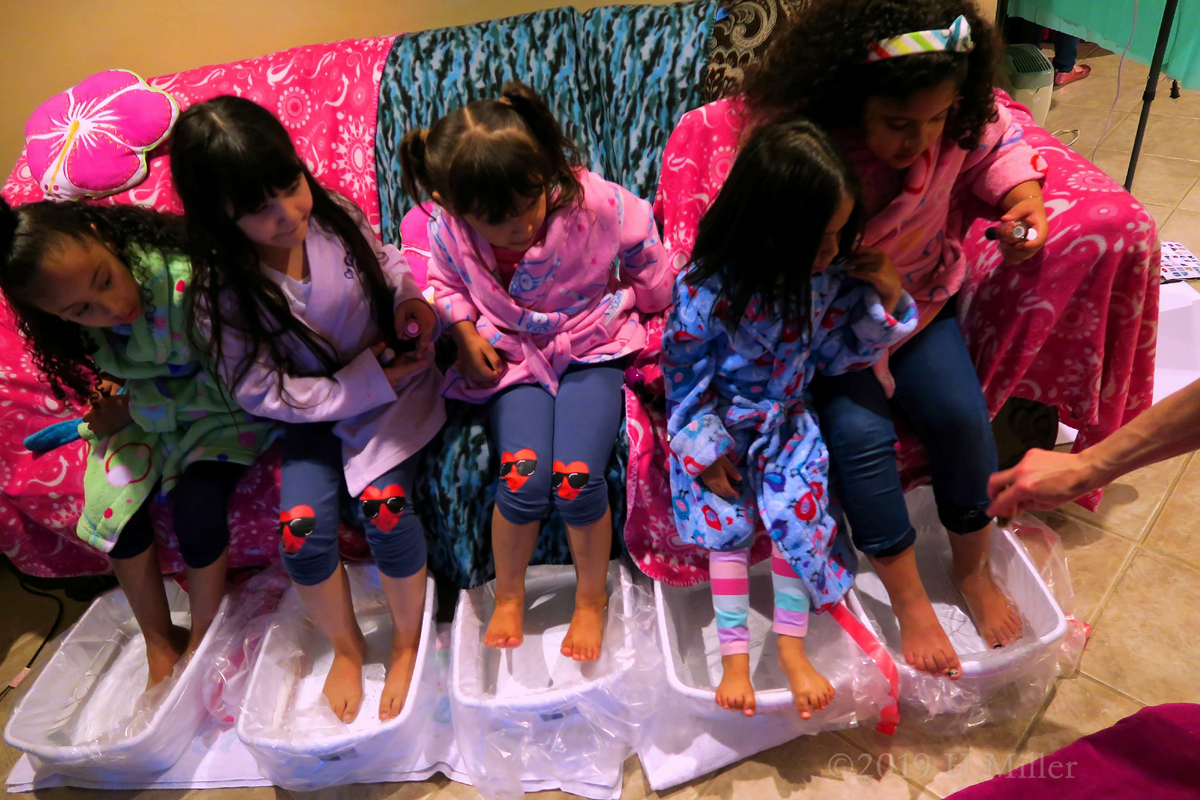 Guests Getting Their Kids Pedicure At The Spa Birthday Party 