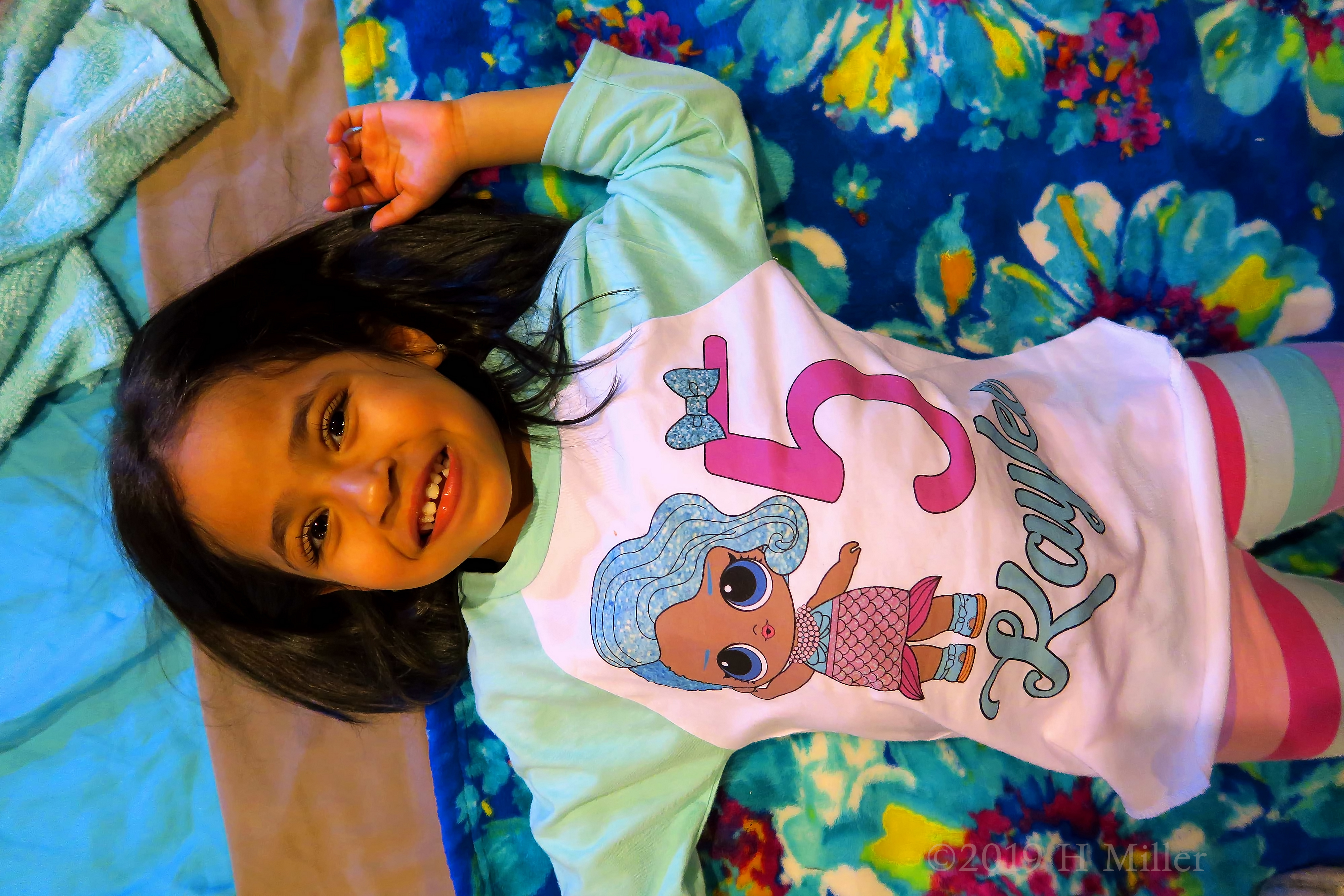 A Smiling Birthday Girl Lying On The Colorful Spa Mat Before Her Kids Facial! 4 A Smiling Birthday Girl Lying On The Colorful Spa Mat Before Her Kids Facial! 4