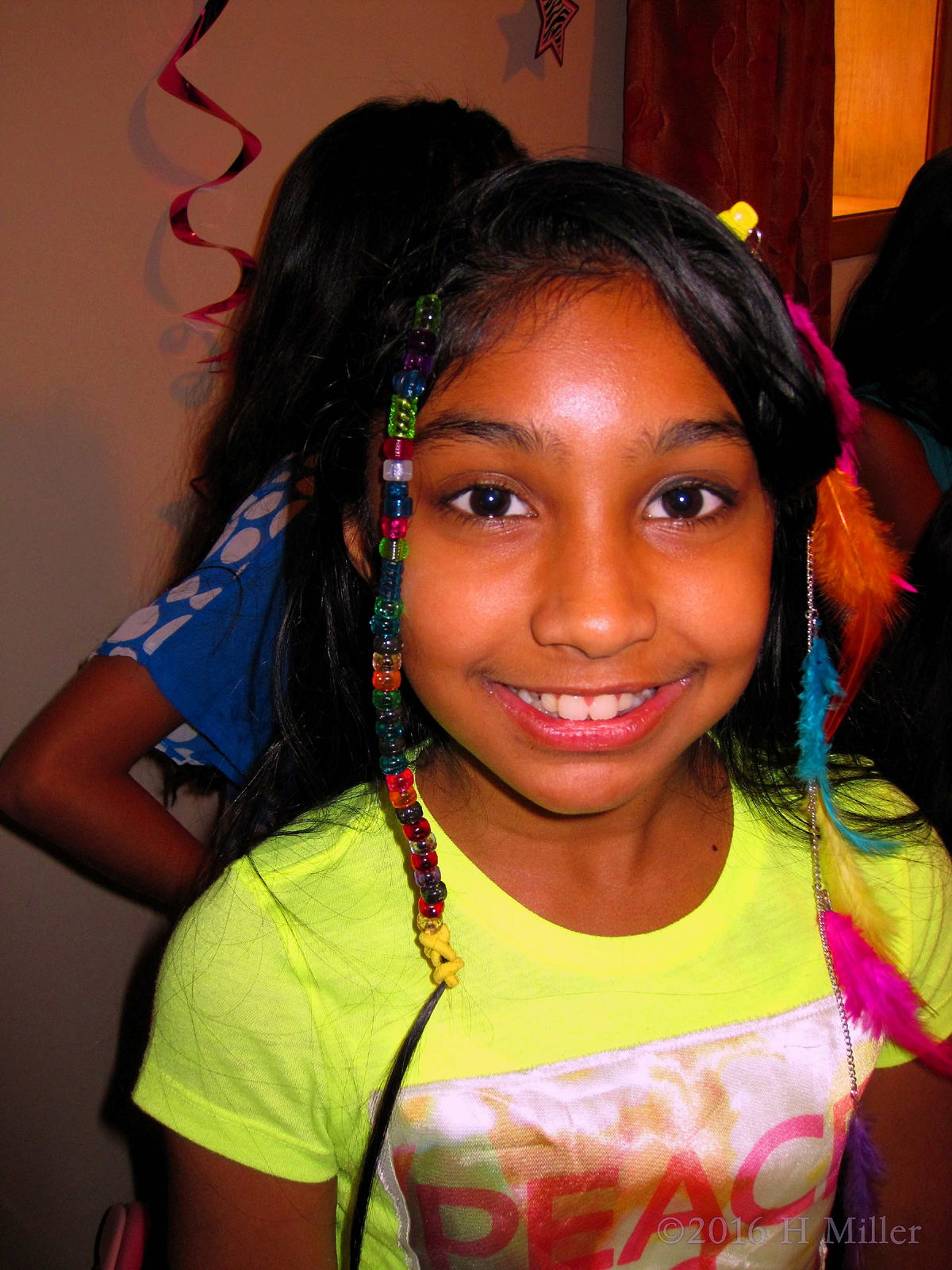 Looking Cute With A Beaded Hairstyle And A Feather Extension! 
