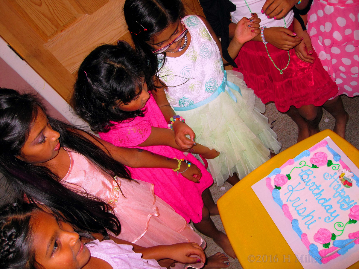 The Girls Are Admiring The Birthday Cake. 