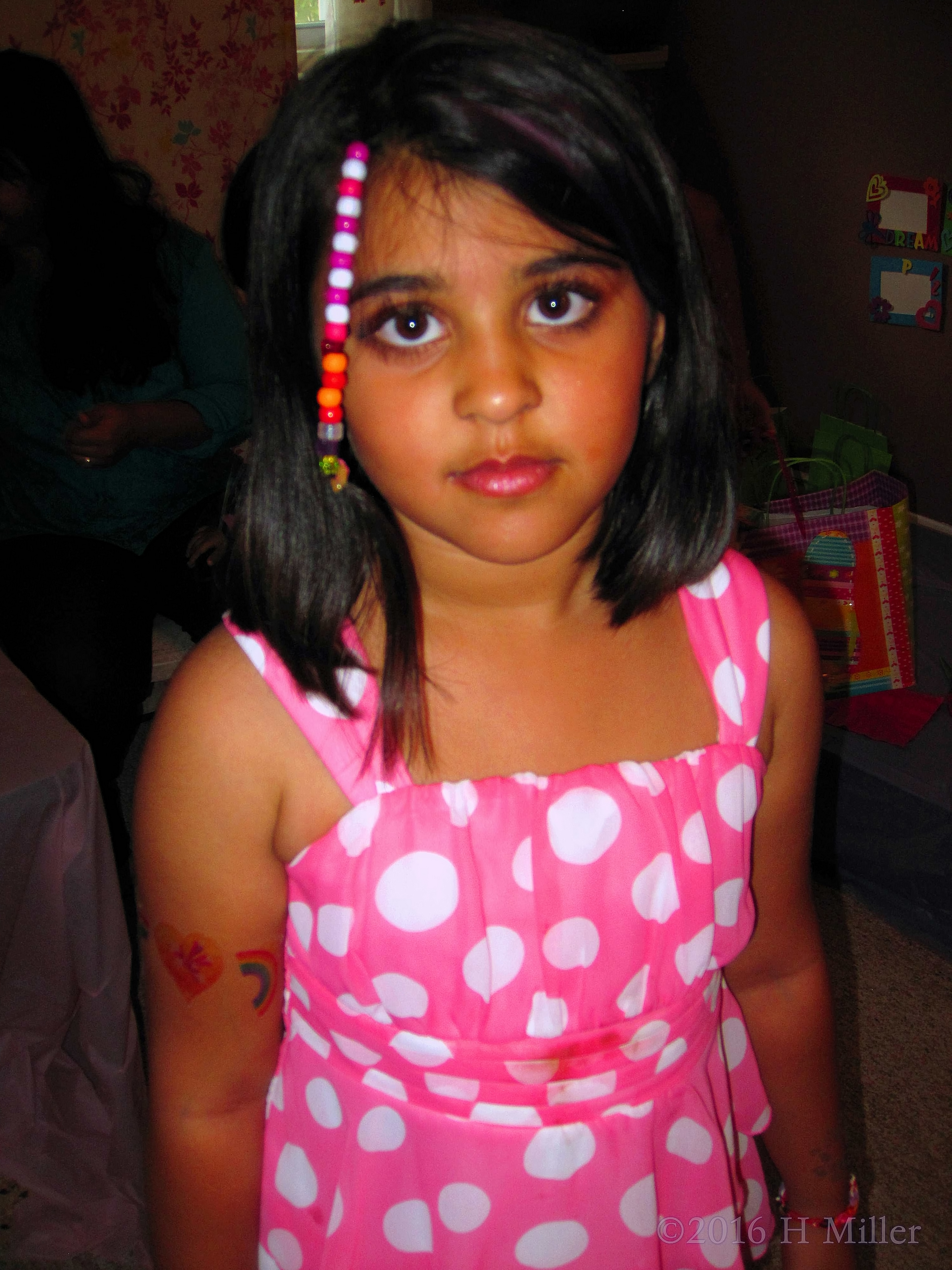 Her Beaded Strand Matches Her Dress. Her Beaded Strand Matches Her Dress.