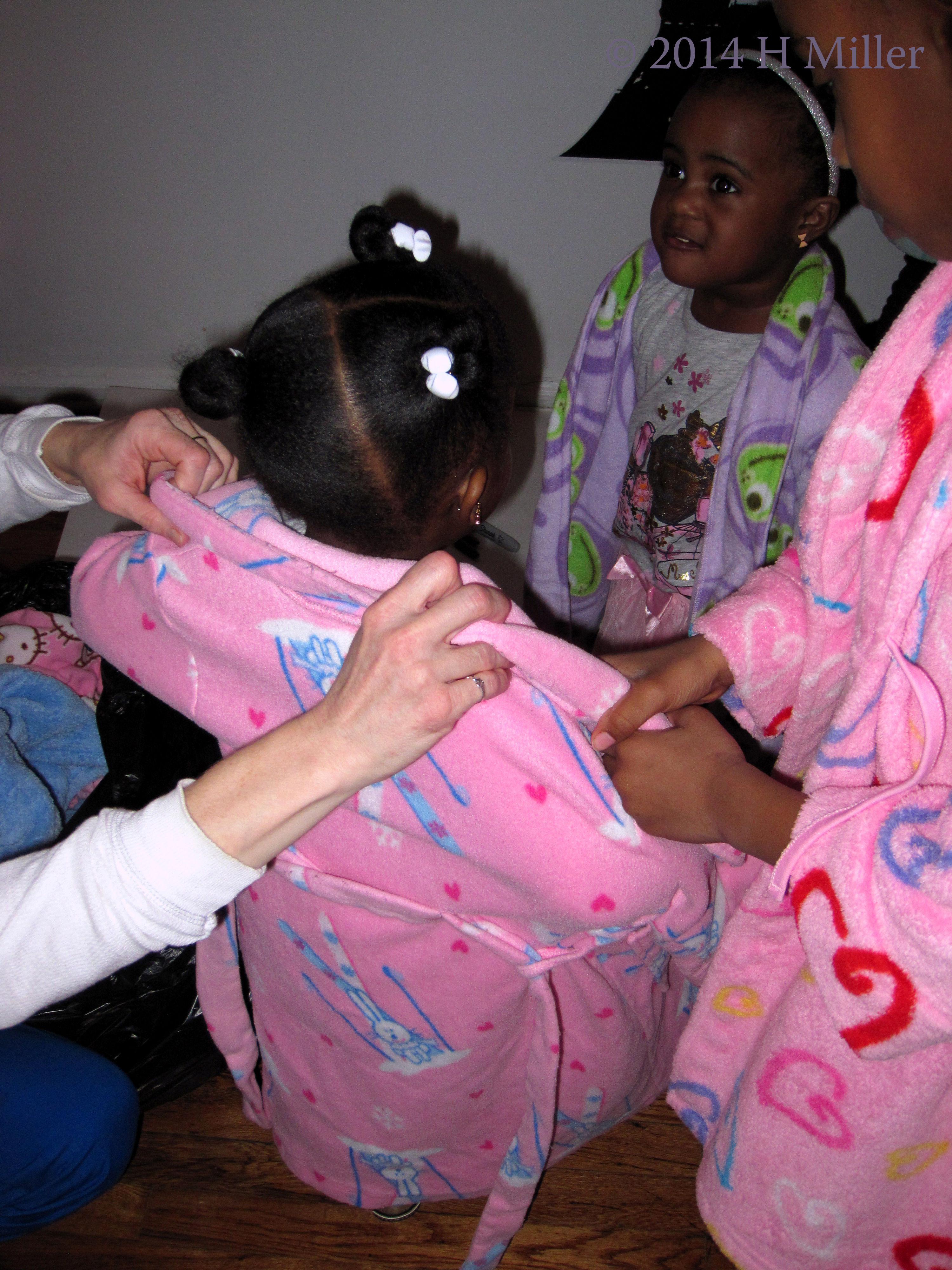 Helping The Baby With Her Robe. 