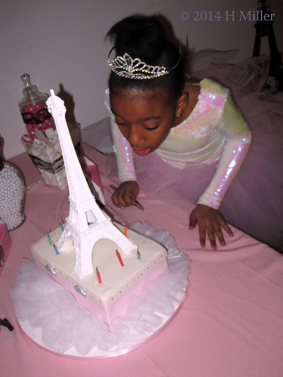 Blowing Out The Candles On The Spa Makeup Case Eiffel Tower Cake. 