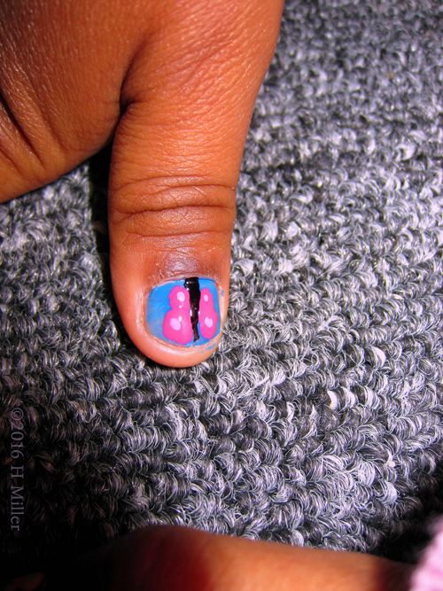 She Has A Butterfly Nail Design On Her Nails!