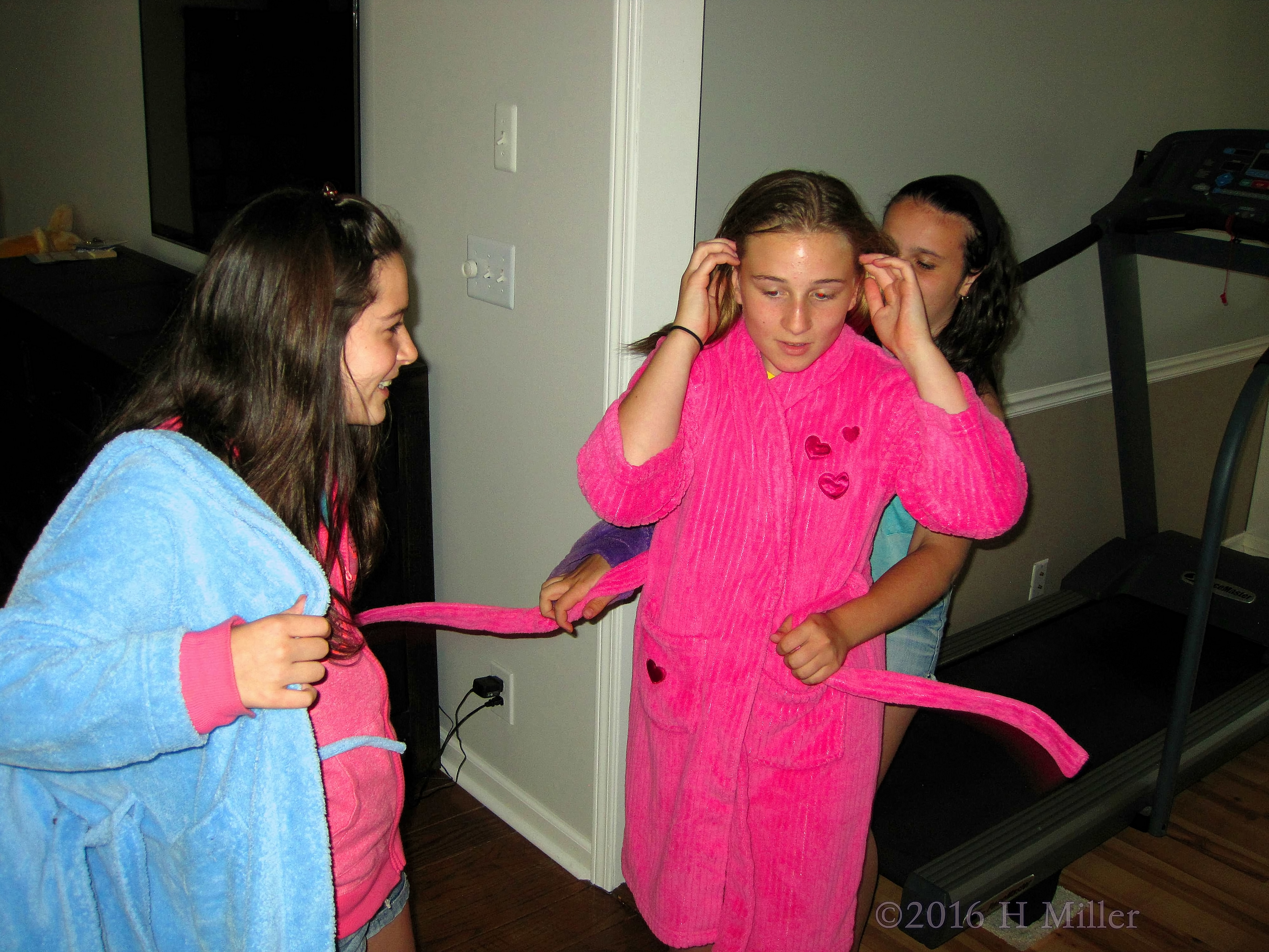 Helping Each Other Put On Spa Robes 