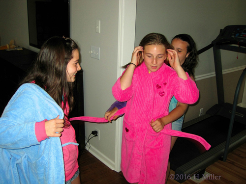 Helping Each Other Put On Spa Robes