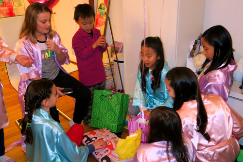 Birthday Girl Is Overjoyed With So Many Gifts Around. Birthday Girl Is Overjoyed With So Many Gifts Around.