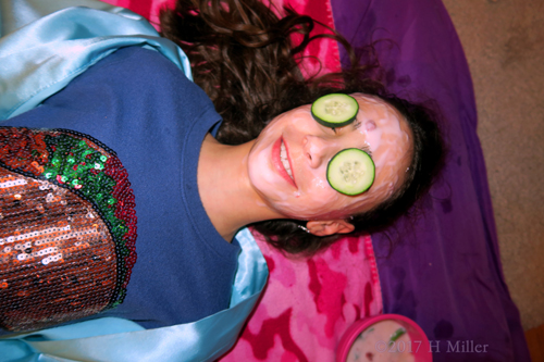 She Smiles Big During Her Relaxing Kids Facial.