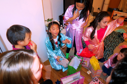 The Girls Having Fun Opening Gifts At The Kids Spa Birthday Party!