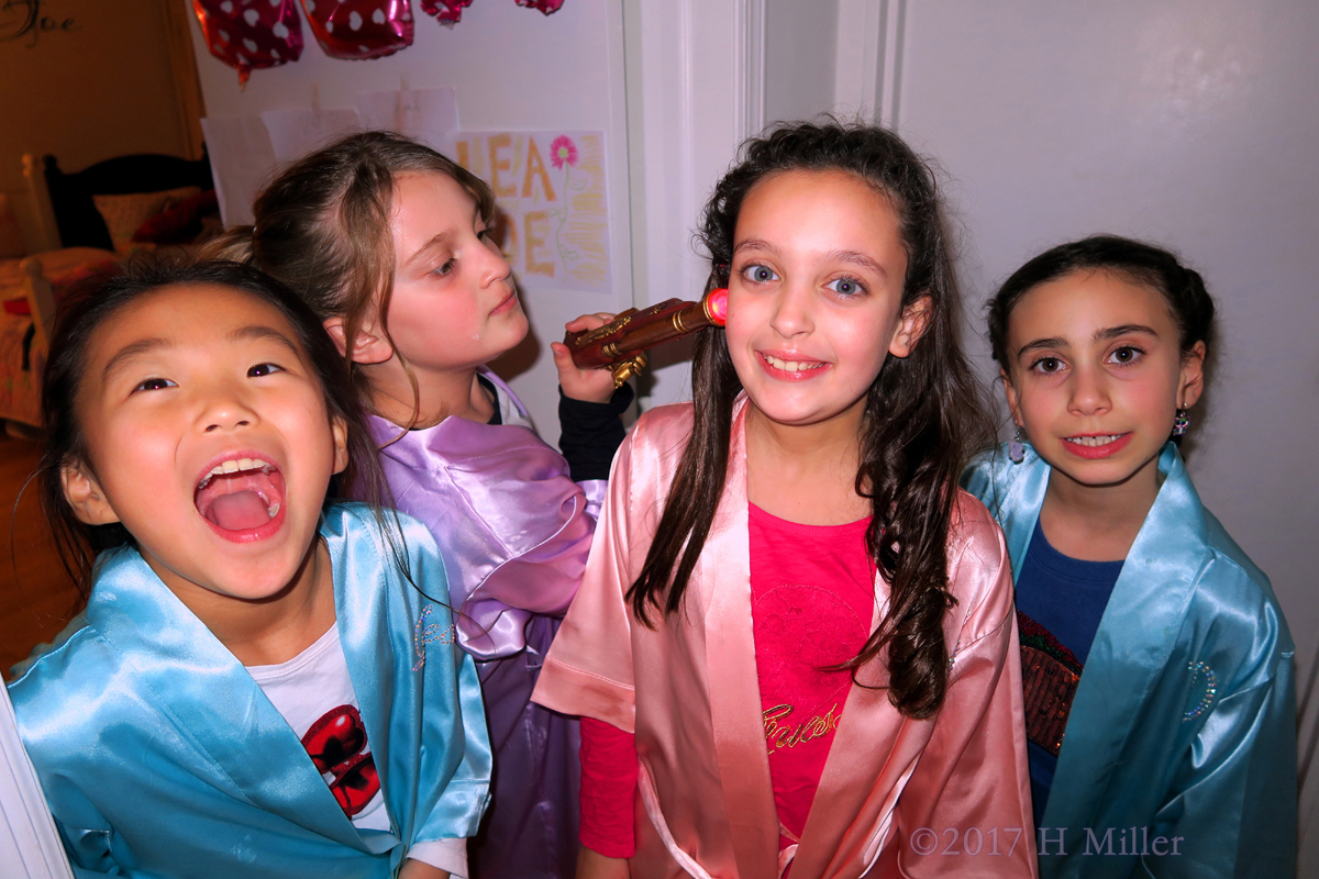 Little Girls Have Fun With The Toy Gun And Make Funny Faces Too. 