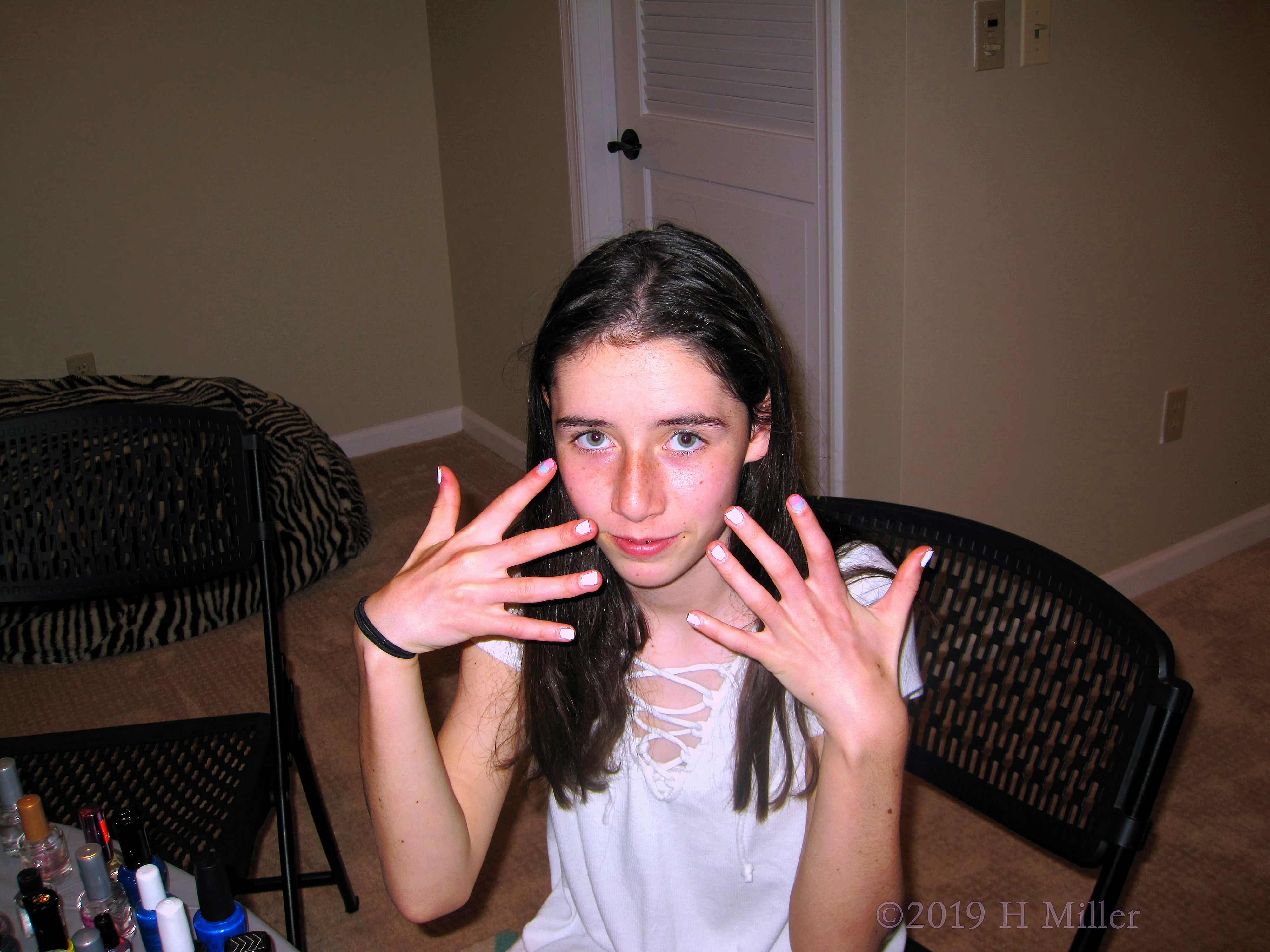 Party Guest Smiling And Showing Off White Kids Manicure Party Guest Smiling And Showing Off White Kids Manicure