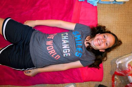 Girl Lying On Colorful Spa Mat