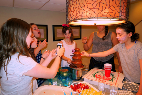 Girl Taking Pictures Of Yummy Chocolate Fountain Girl Taking Pictures Of Yummy Chocolate Fountain