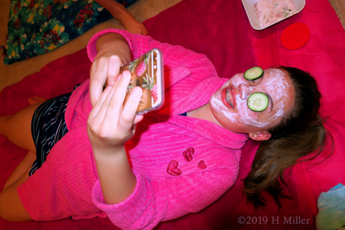 Girls Facial While Checking Her Phone. Girls Facial While Checking Her Phone.